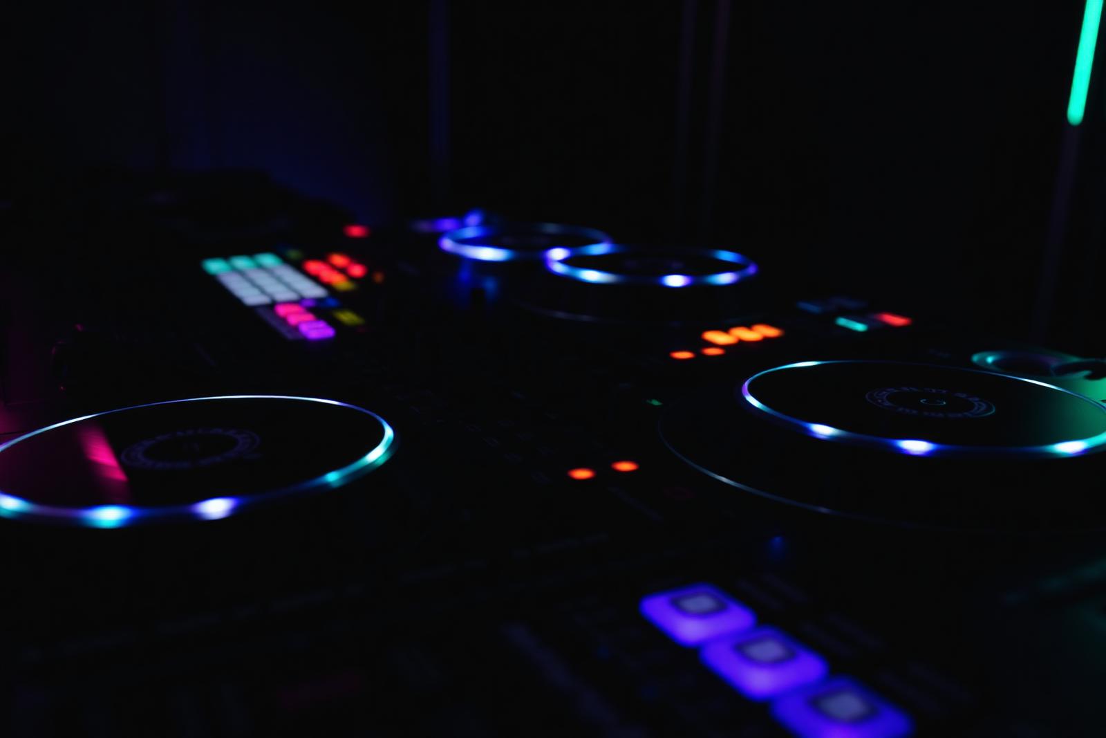 Professional DJ mixing console with glowing LED jog wheels